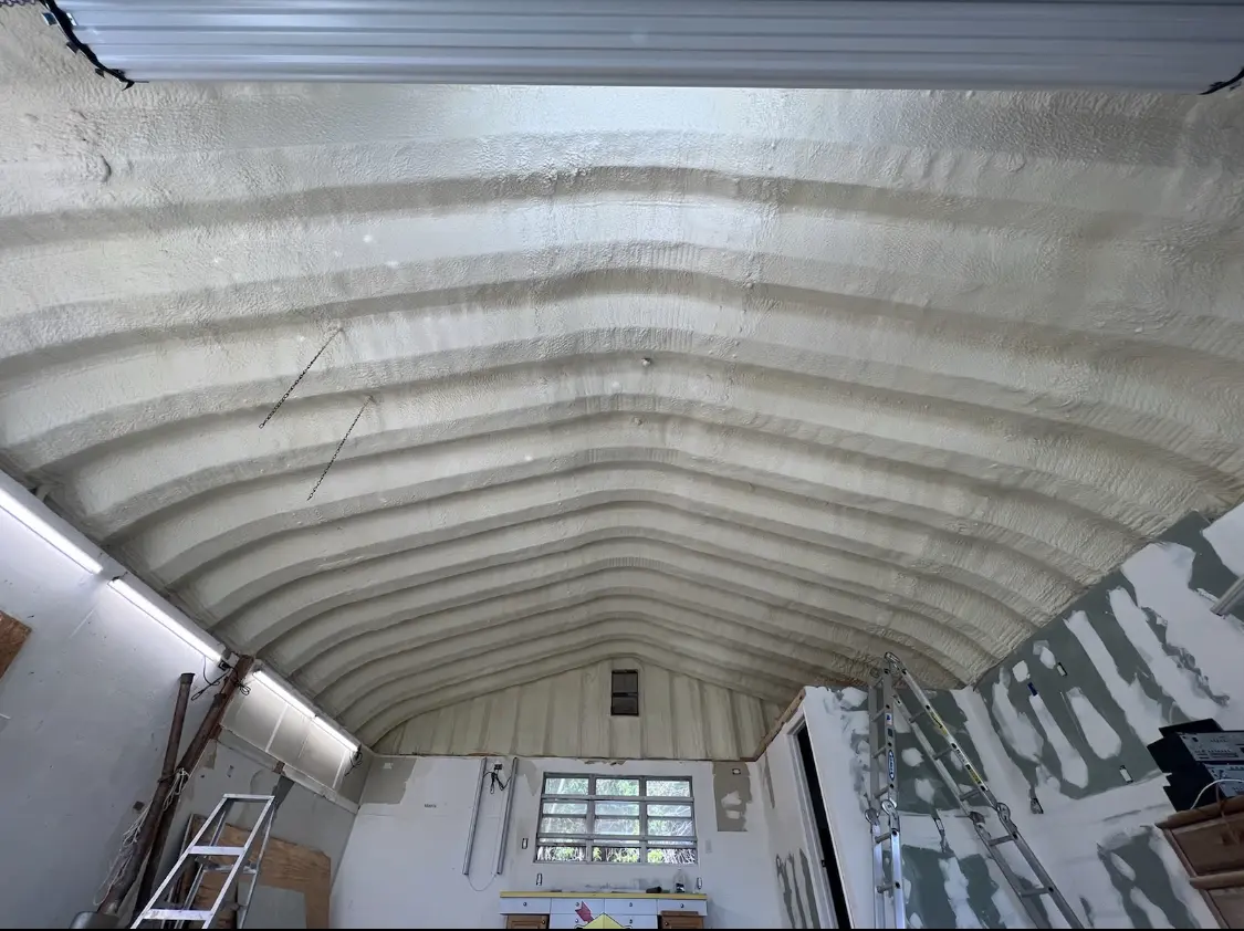 Spray polyurethane foam applied to the underside of a metal roof deck in Reedley